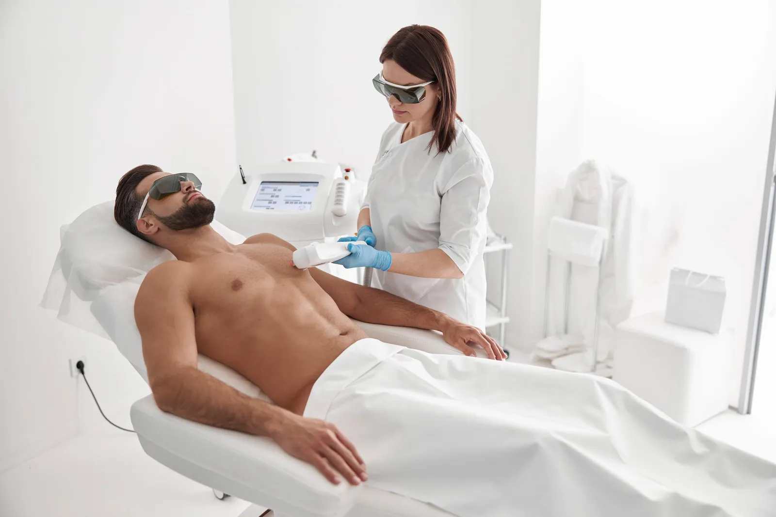 Cosmetologist,Does,Laser,Epilation,Of,Chest,To,Athletic,Man,Using